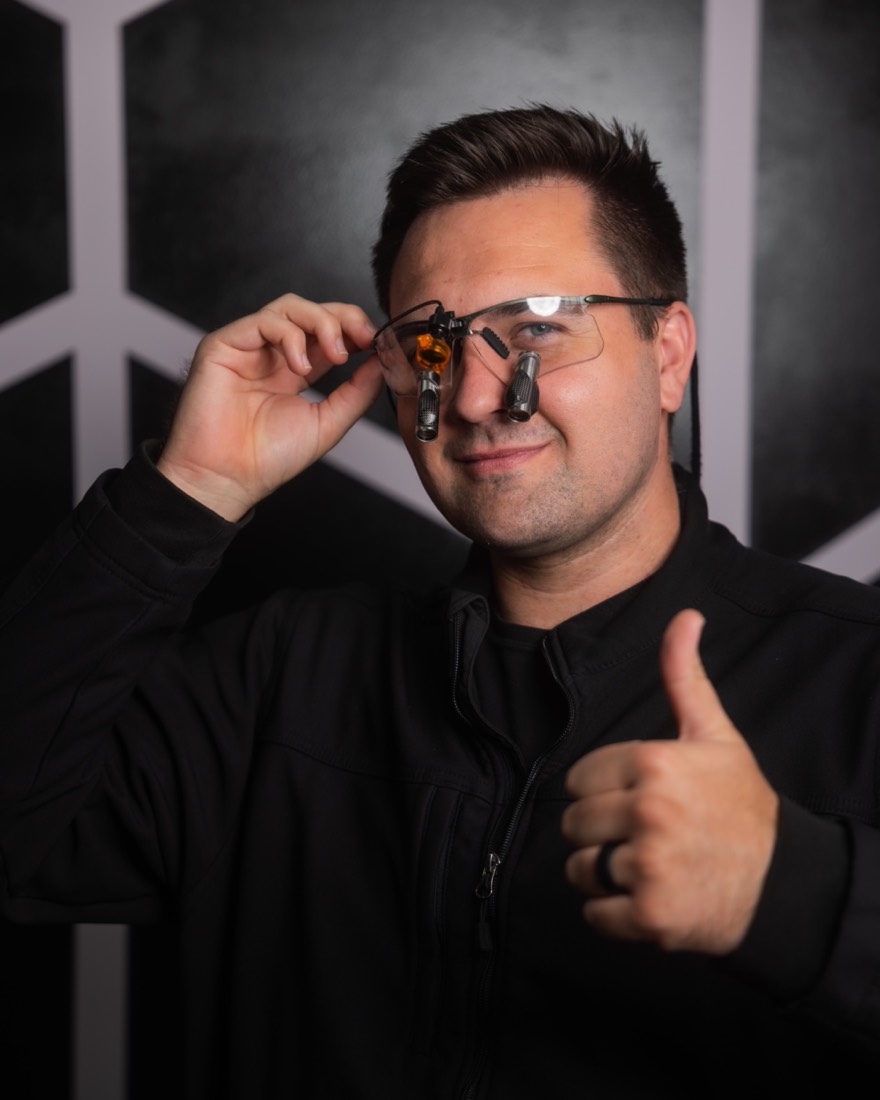 Dr. Groberg, lead dentist and owner of Posh Dental Spa, wearing dental loupes